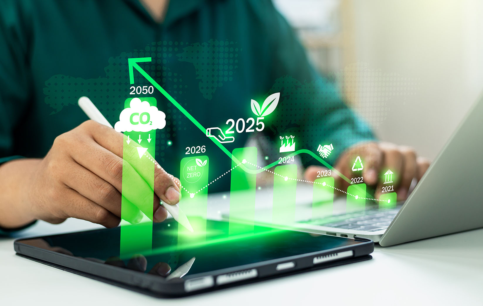 Environmental Integrity Product Destruction Man using an apple pencil on an iPad with other hand on a laptop, while a bar chart indicating an increase in environmental integrity is coming out of the devices